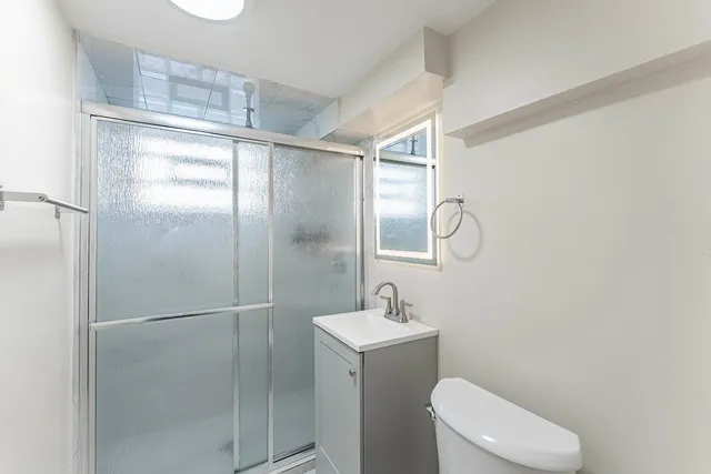 a bathroom with a toilet sink and shower