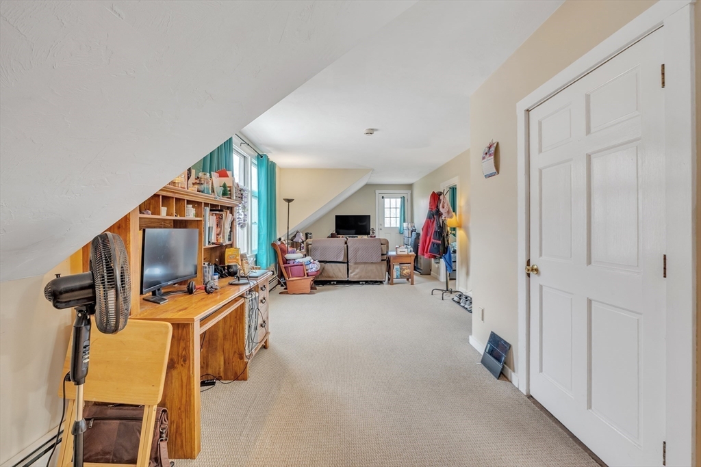 89 Kittery Avenue Rowley, MA 01969 - Photo 27 of 37 a living room with furniture and a flat screen tv