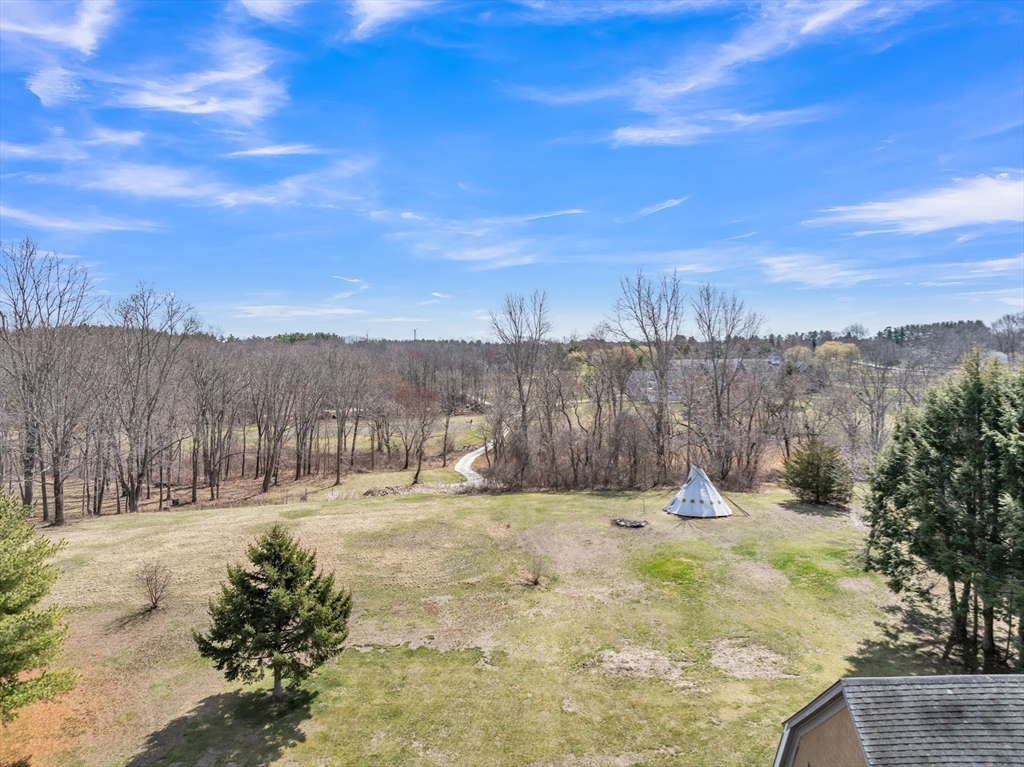 89 Kittery Avenue Rowley, MA 01969 - Photo 33 of 37 a view of a yard with trees in the background