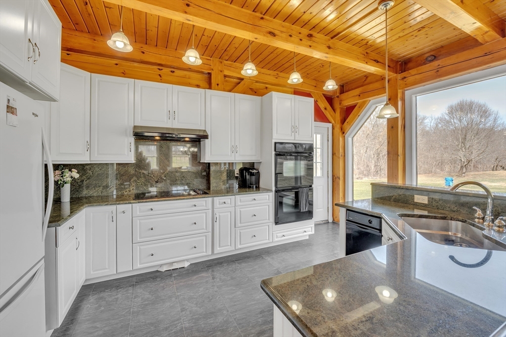 89 Kittery Avenue Rowley, MA 01969 - Photo 4 of 37 a kitchen with stainless steel appliances granite countertop a sink a stove and cabinets