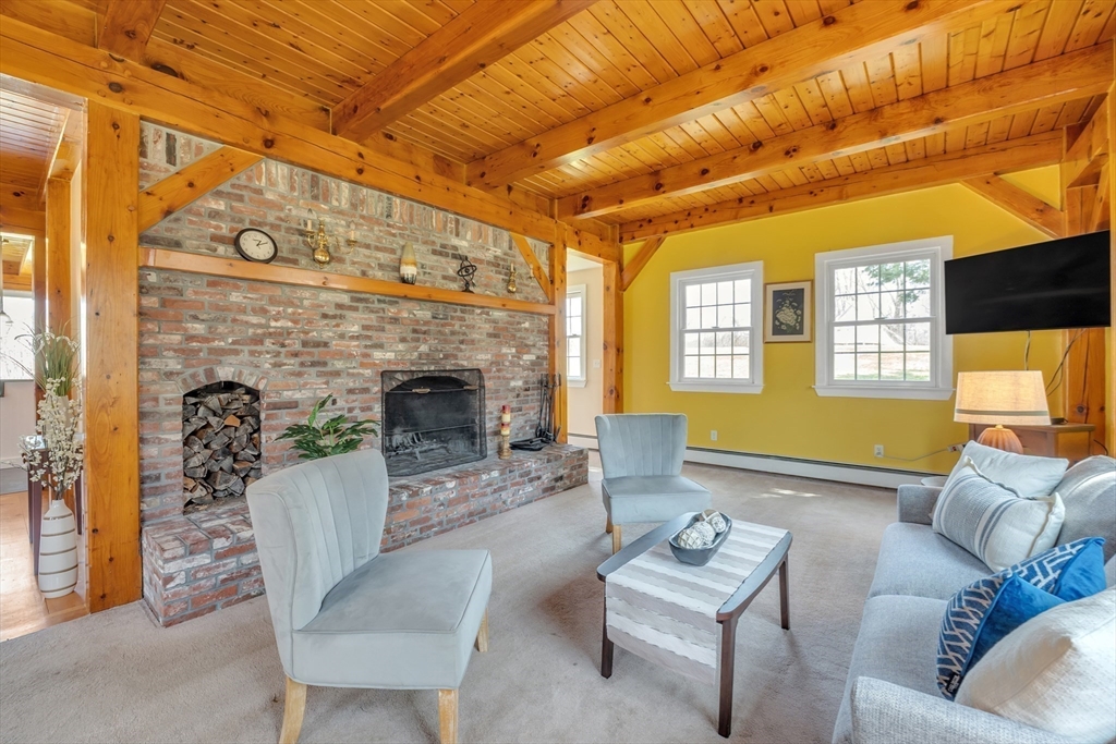 89 Kittery Avenue Rowley, MA 01969 - Photo 10 of 37 a living room with furniture and a fireplace