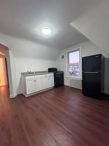 a view of a kitchen with a sink and a refrigerator