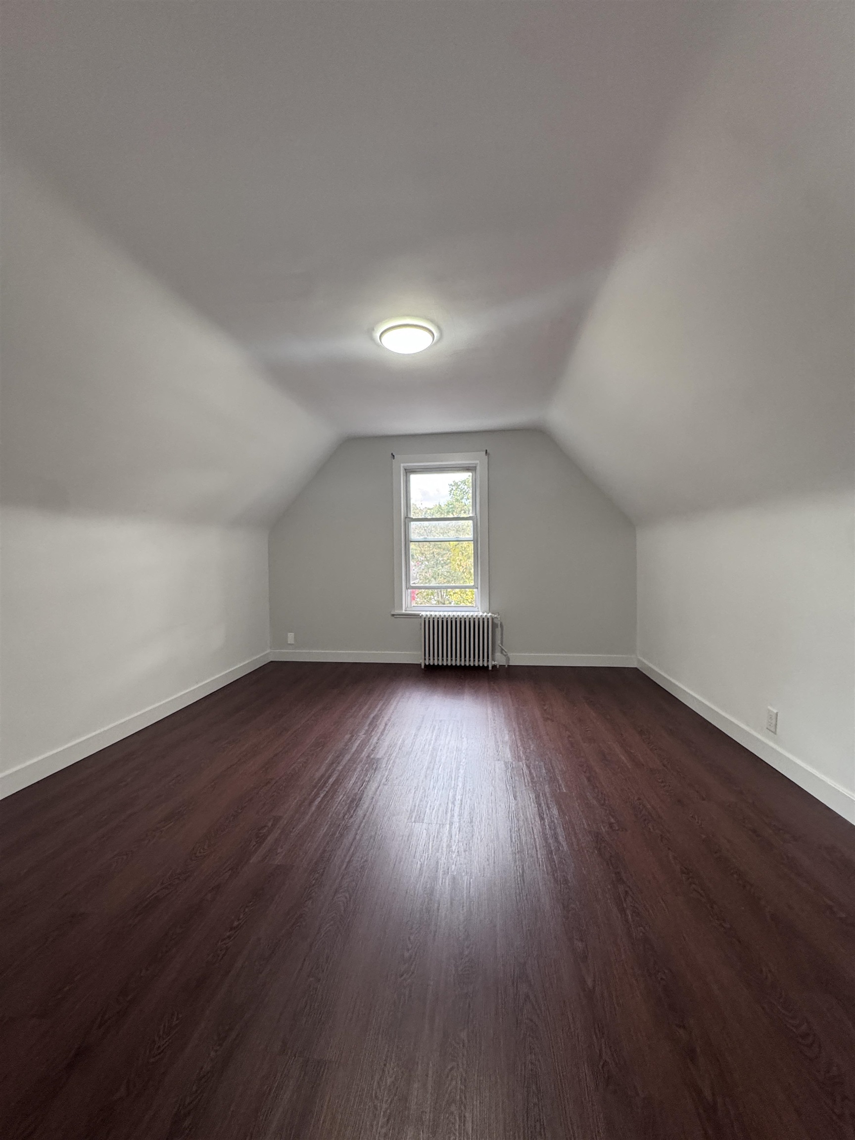 510 Shaler Boulevard, Unit 3 Ridgefield, NJ 07657 - Photo 5 of 7 an empty room with wooden floor and windows