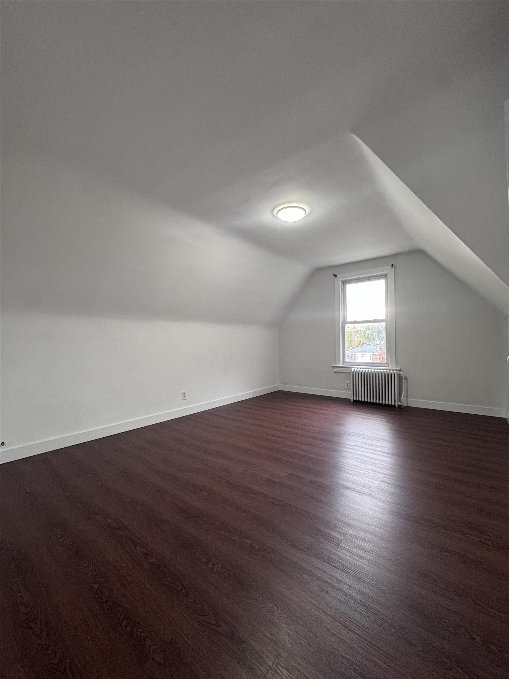 510 Shaler Boulevard, Unit 3 Ridgefield, NJ 07657 - Photo 6 of 7 an empty room with wooden floor and windows