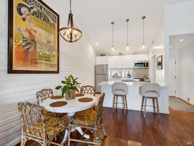 a view of a dining room with furniture wooden floor and a chandelier