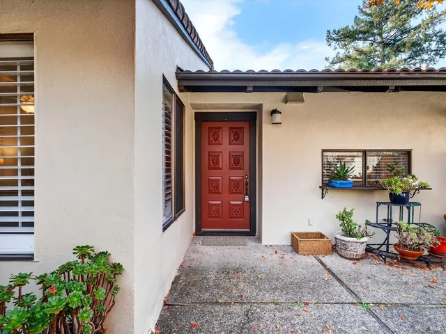 a view of a patio with couches chairs and a yard