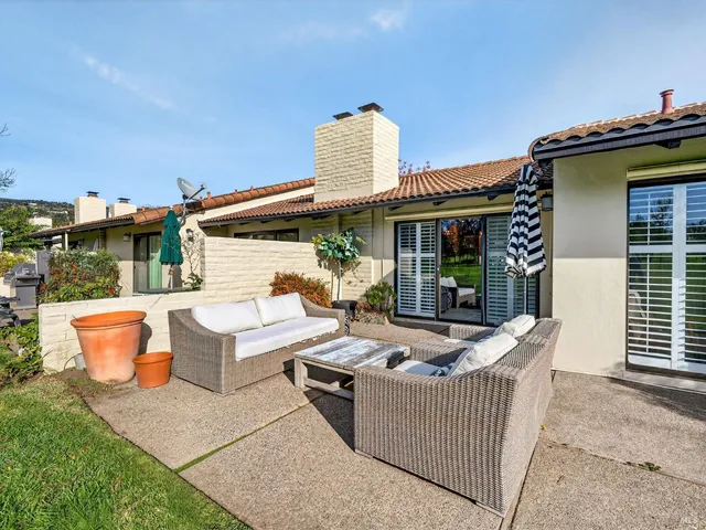 a front view of a house with outdoor seating
