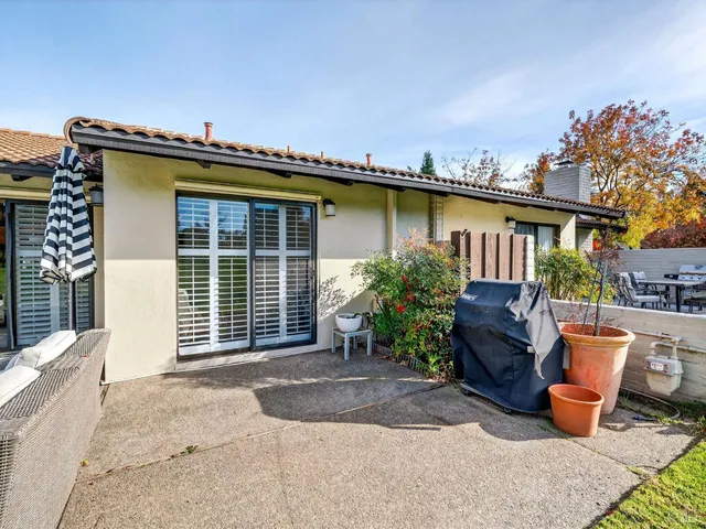 a view of a patio with furniture and garden