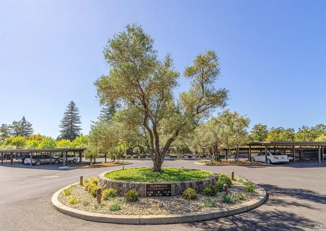 a view of a patio with a table and chairs under an umbrella