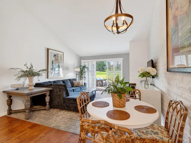 a dining room with furniture a chandelier and a table