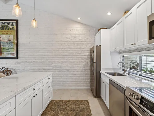 a kitchen with a sink stove and refrigerator