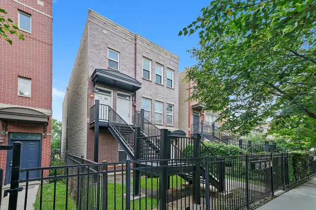 a view of a house with wooden fence