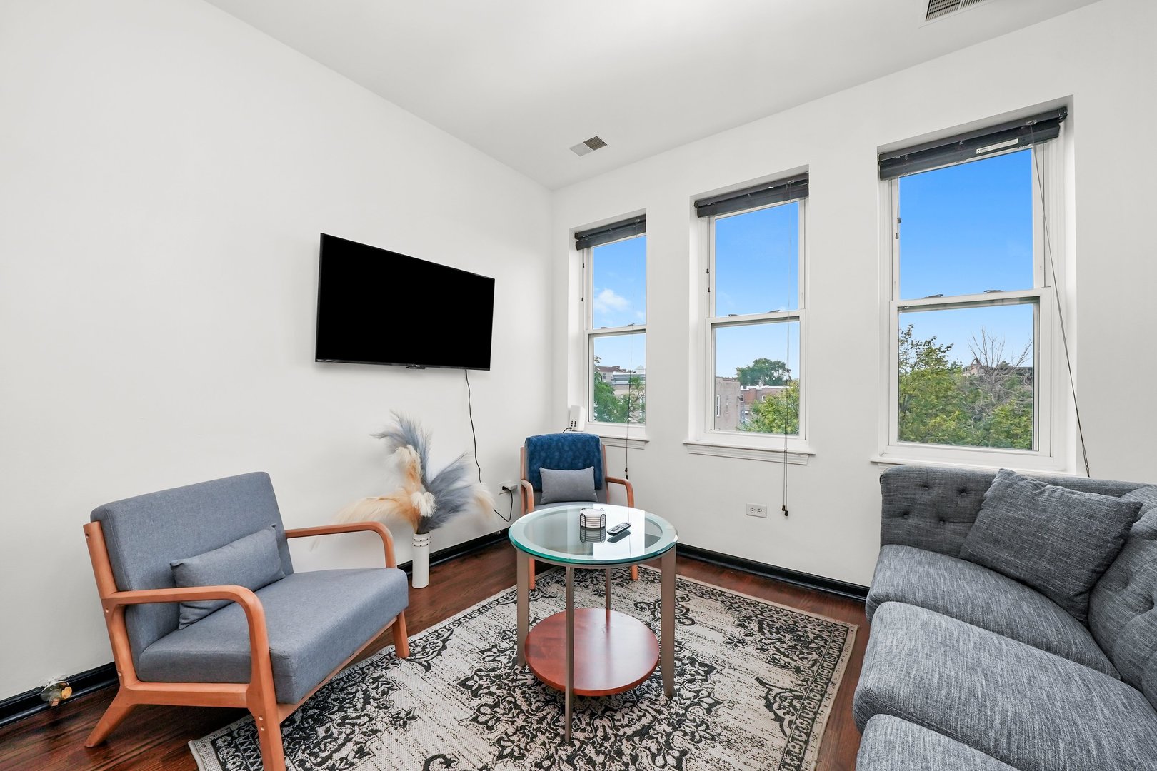 2432 West Harrison Street, Unit 3 Chicago, IL 60612 - Photo 13 of 32 a living room with furniture a flat screen tv and a window