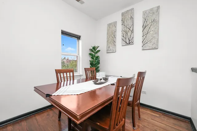 a view of a dining room with furniture and wooden floor