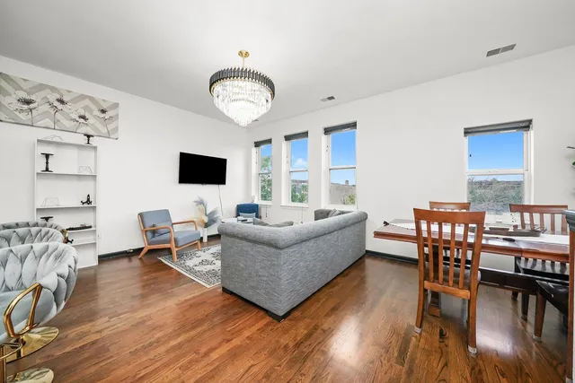 a living room with furniture dining table and a flat screen tv