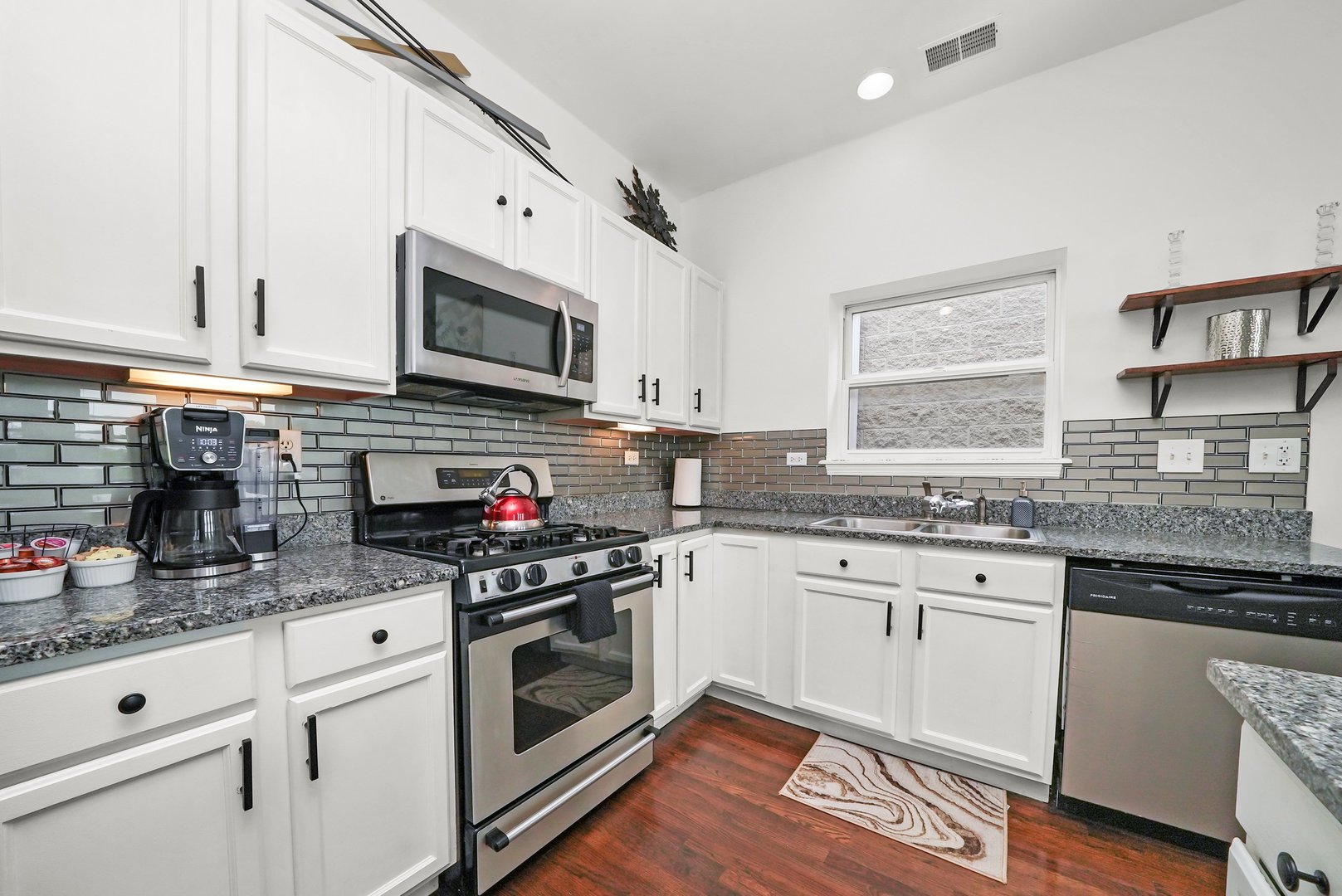 2432 West Harrison Street, Unit 3 Chicago, IL 60612 - Photo 17 of 32 a kitchen with granite countertop a stove sink and cabinets