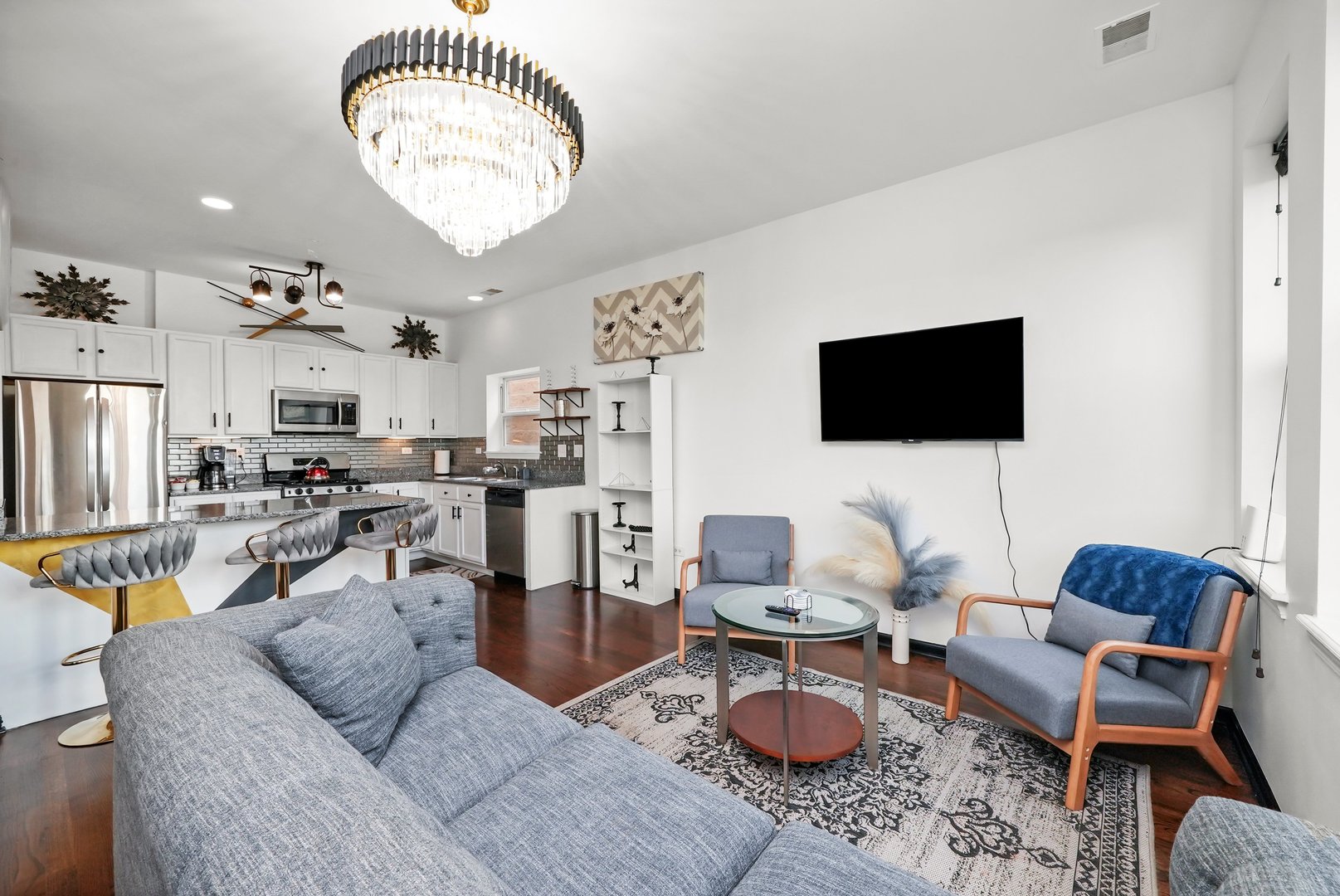 2432 West Harrison Street, Unit 3 Chicago, IL 60612 - Photo 23 of 32 a living room with furniture a flat screen tv and kitchen view