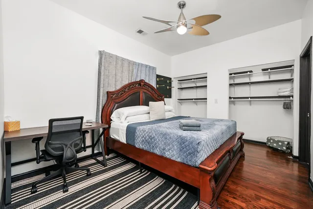 a bedroom with a bed and a chandelier