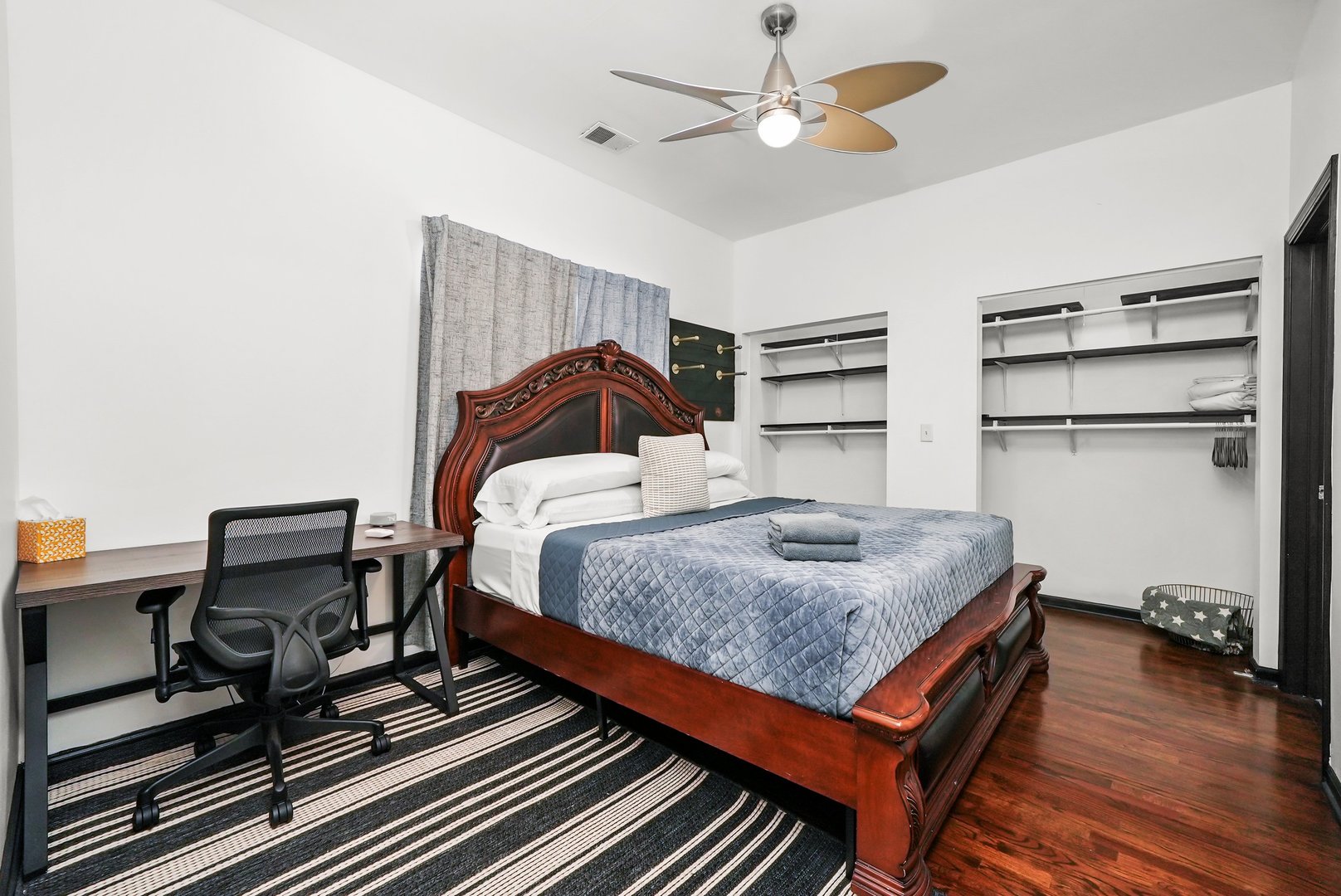 2432 West Harrison Street, Unit 3 Chicago, IL 60612 - Photo 26 of 32 a bedroom with a bed and a chandelier