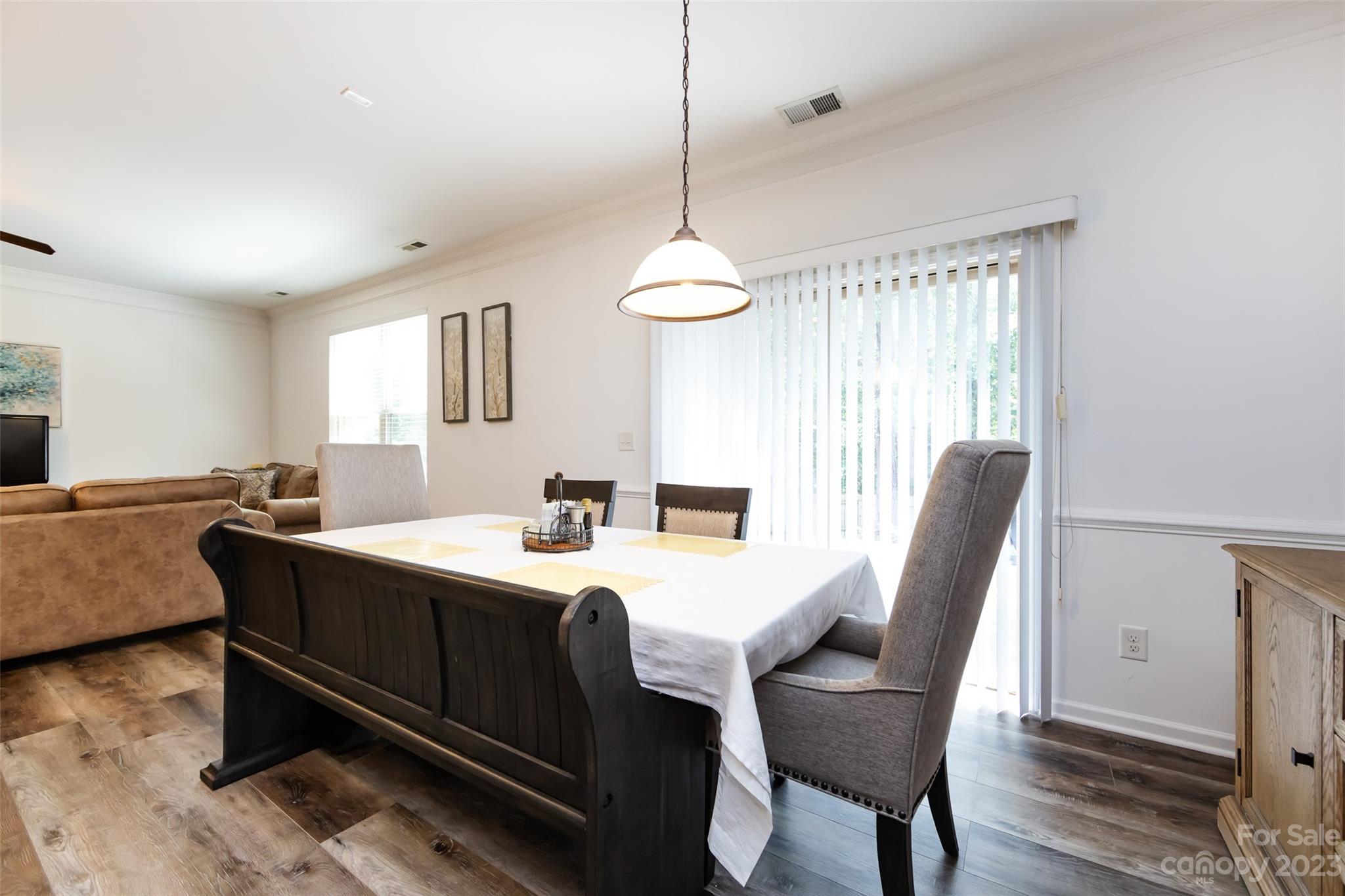 807 Rook Road Charlotte, NC 28216 - Photo 12 of 43 a view of a dining room with furniture window and wooden floor