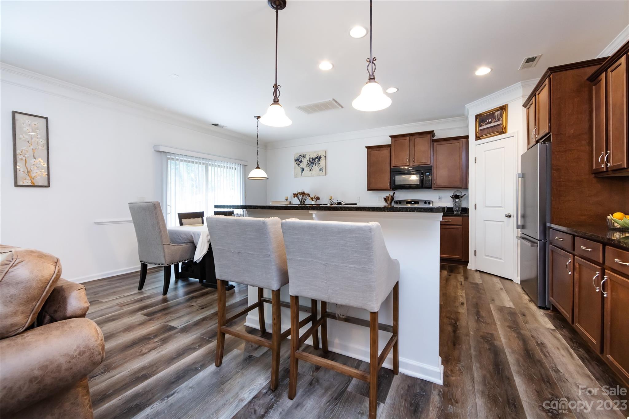 807 Rook Road Charlotte, NC 28216 - Photo 15 of 43 a kitchen with stainless steel appliances granite countertop a stove a refrigerator a kitchen island a sink and a refrigerator