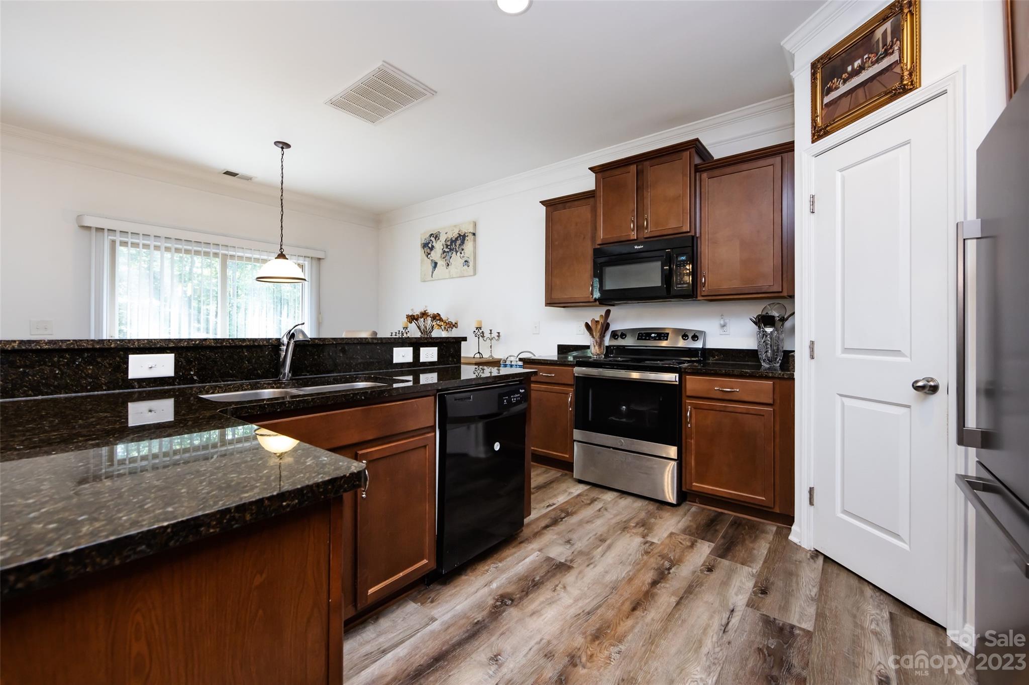 807 Rook Road Charlotte, NC 28216 - Photo 17 of 43 a kitchen with stainless steel appliances granite countertop a stove a sink and a refrigerator
