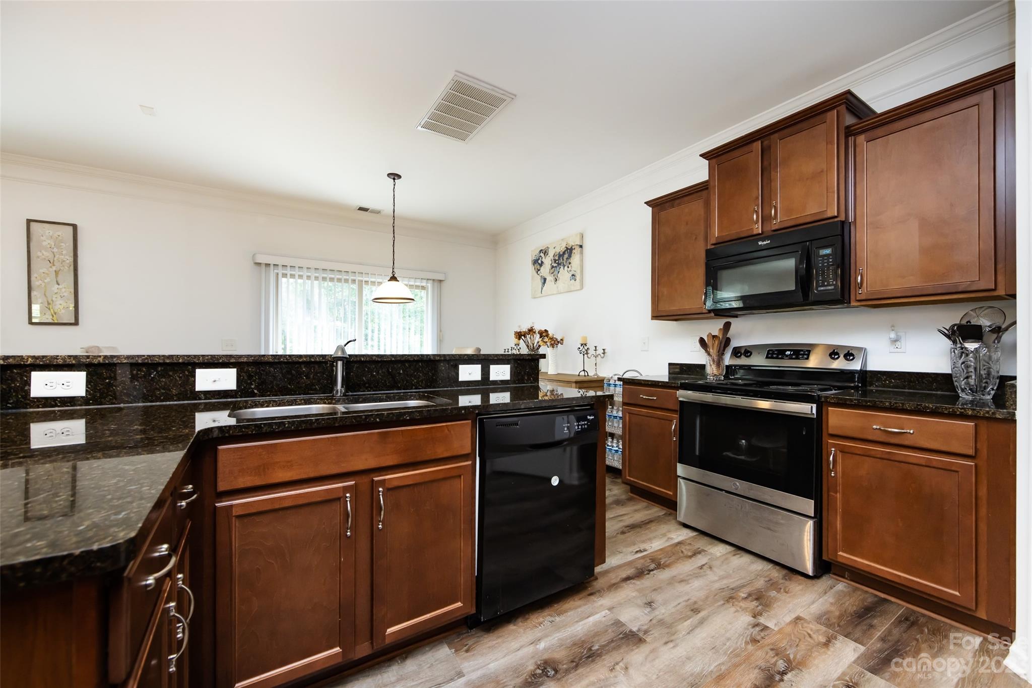 807 Rook Road Charlotte, NC 28216 - Photo 18 of 43 a kitchen with granite countertop a sink cabinets and stainless steel appliances