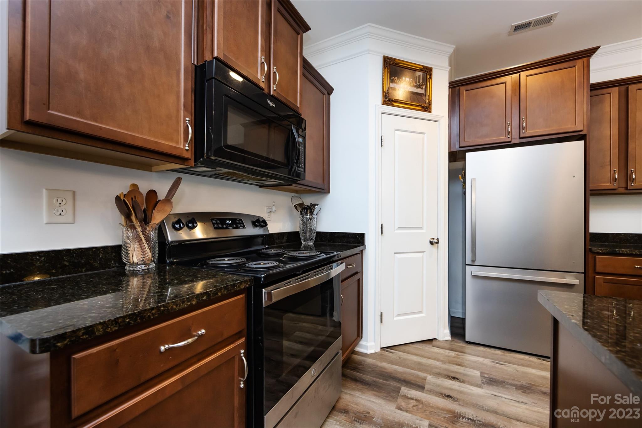 807 Rook Road Charlotte, NC 28216 - Photo 19 of 43 a kitchen with stainless steel appliances granite countertop a refrigerator stove and microwave