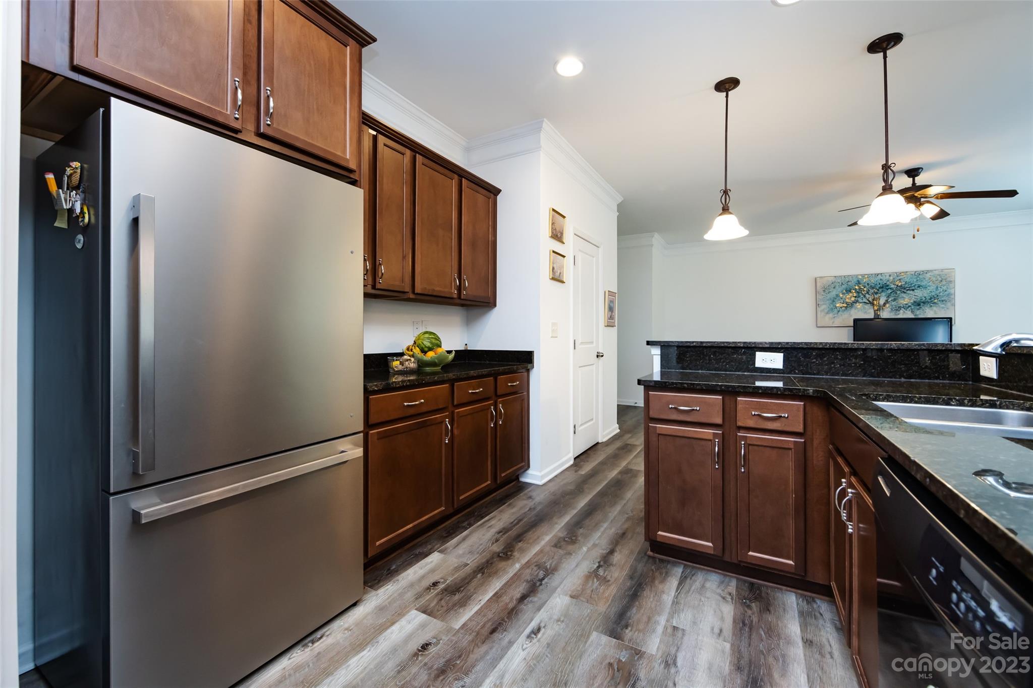 807 Rook Road Charlotte, NC 28216 - Photo 20 of 43 a kitchen with stainless steel appliances granite countertop a refrigerator a sink and wooden cabinets