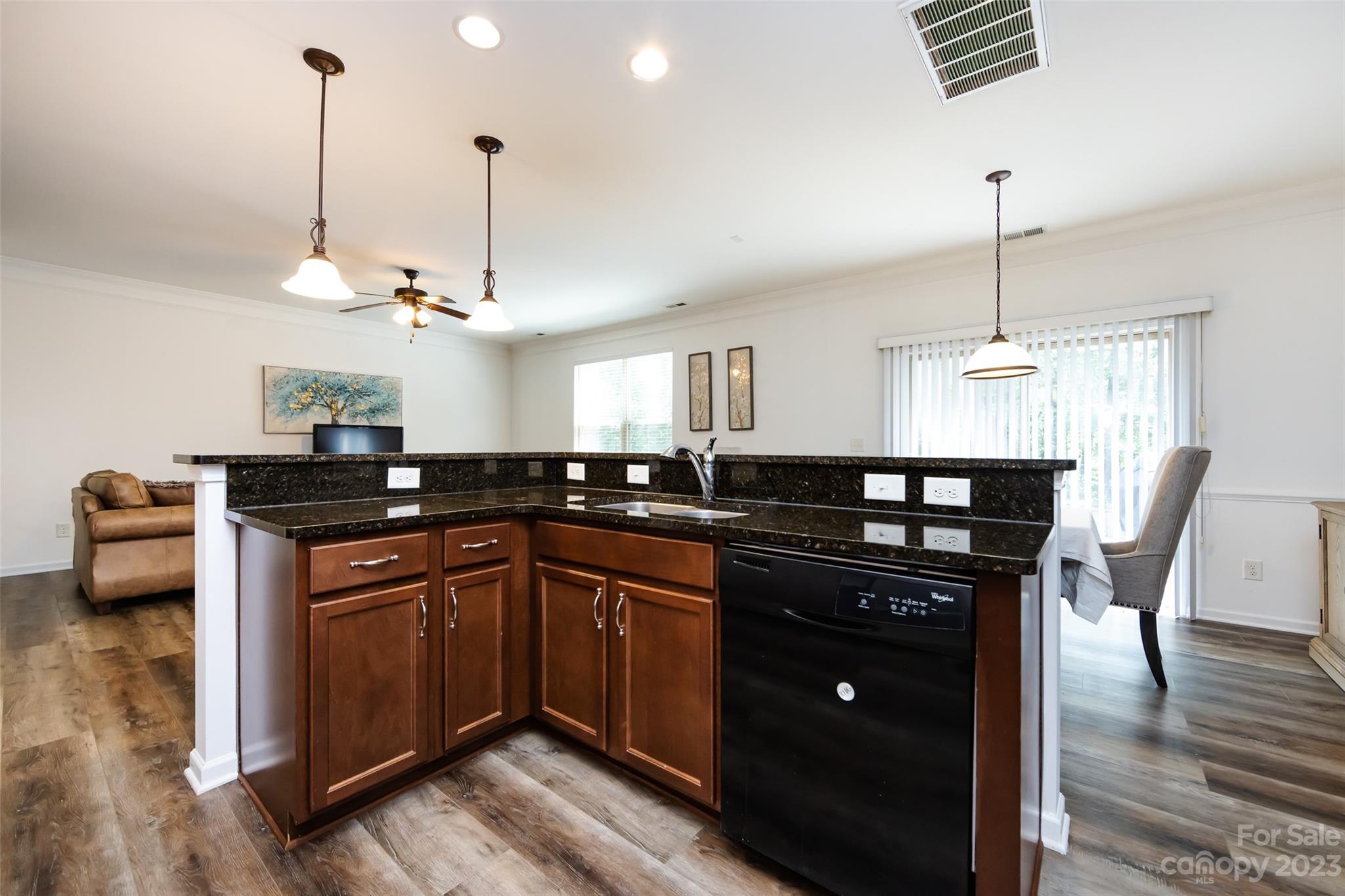 807 Rook Road Charlotte, NC 28216 - Photo 21 of 43 a kitchen with stainless steel appliances granite countertop a sink a stove and a wooden floors