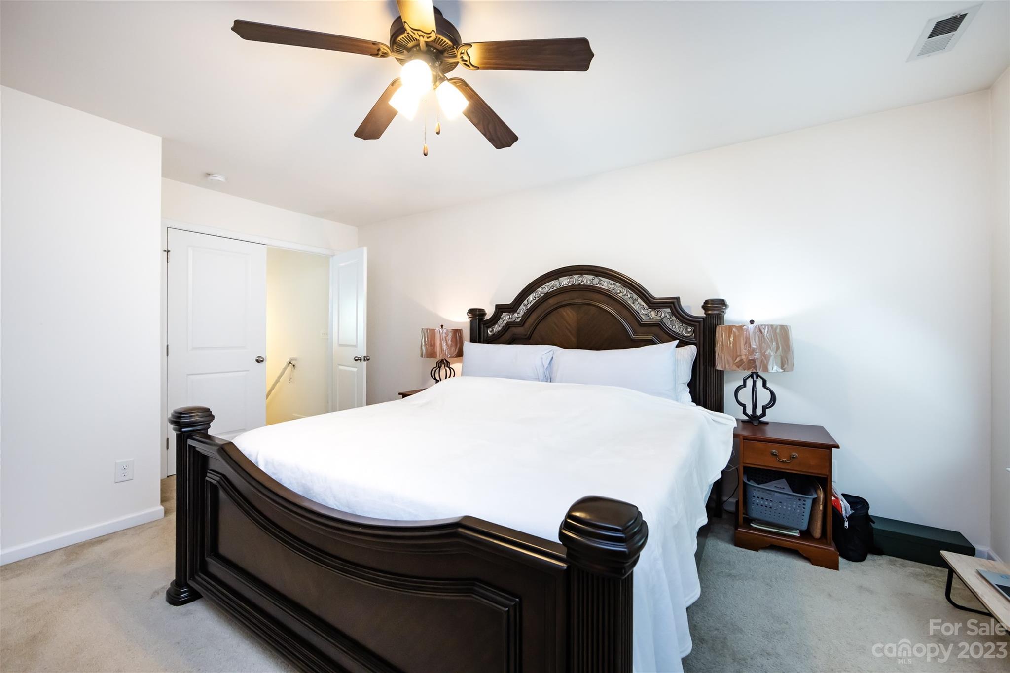 807 Rook Road Charlotte, NC 28216 - Photo 29 of 43 a bedroom with a bed and a chandelier