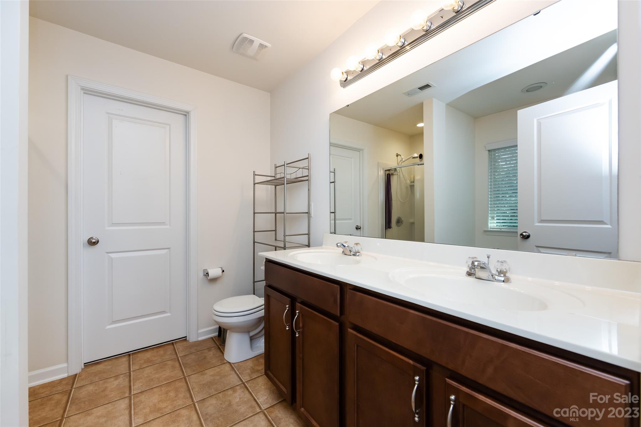 807 Rook Road Charlotte, NC 28216 - Photo 30 of 43 a bathroom with a sink a toilet and a mirror