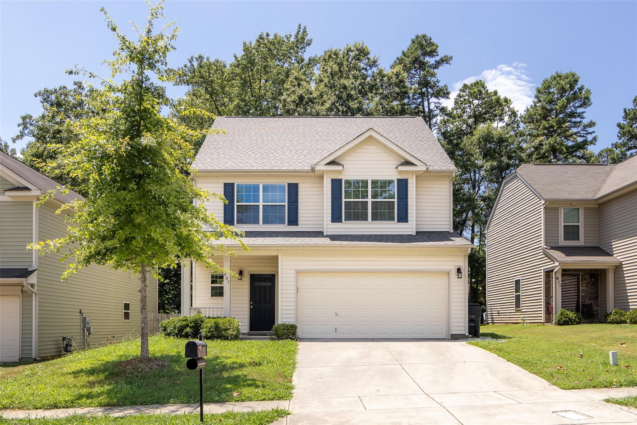 807 Rook Road Charlotte, NC 28216 - Photo 3 of 43 a front view of a house with a garden