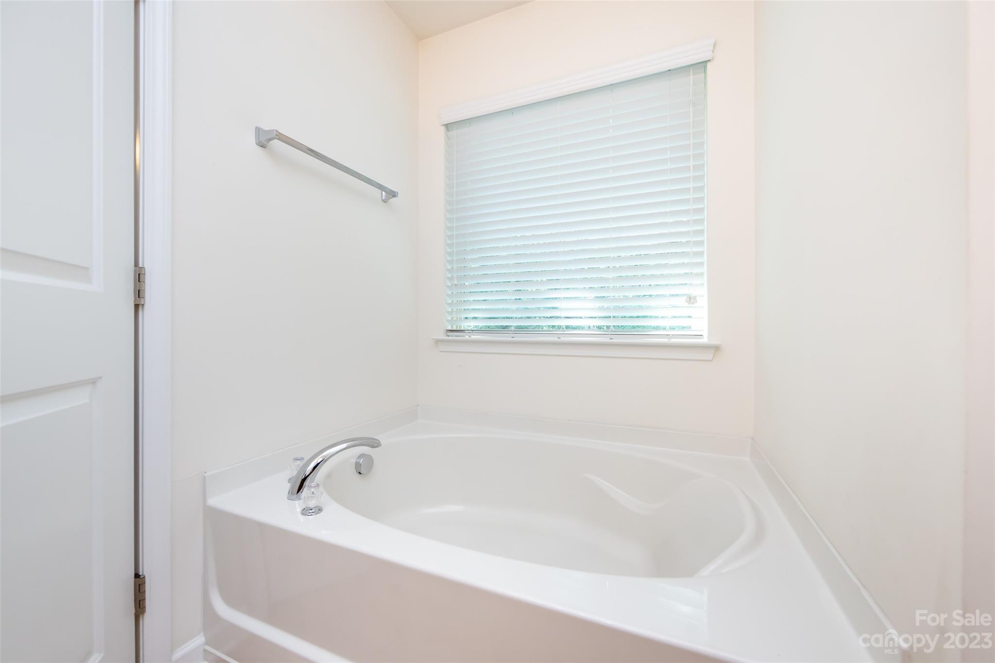 807 Rook Road Charlotte, NC 28216 - Photo 32 of 43 a white bath tub sitting next to a window
