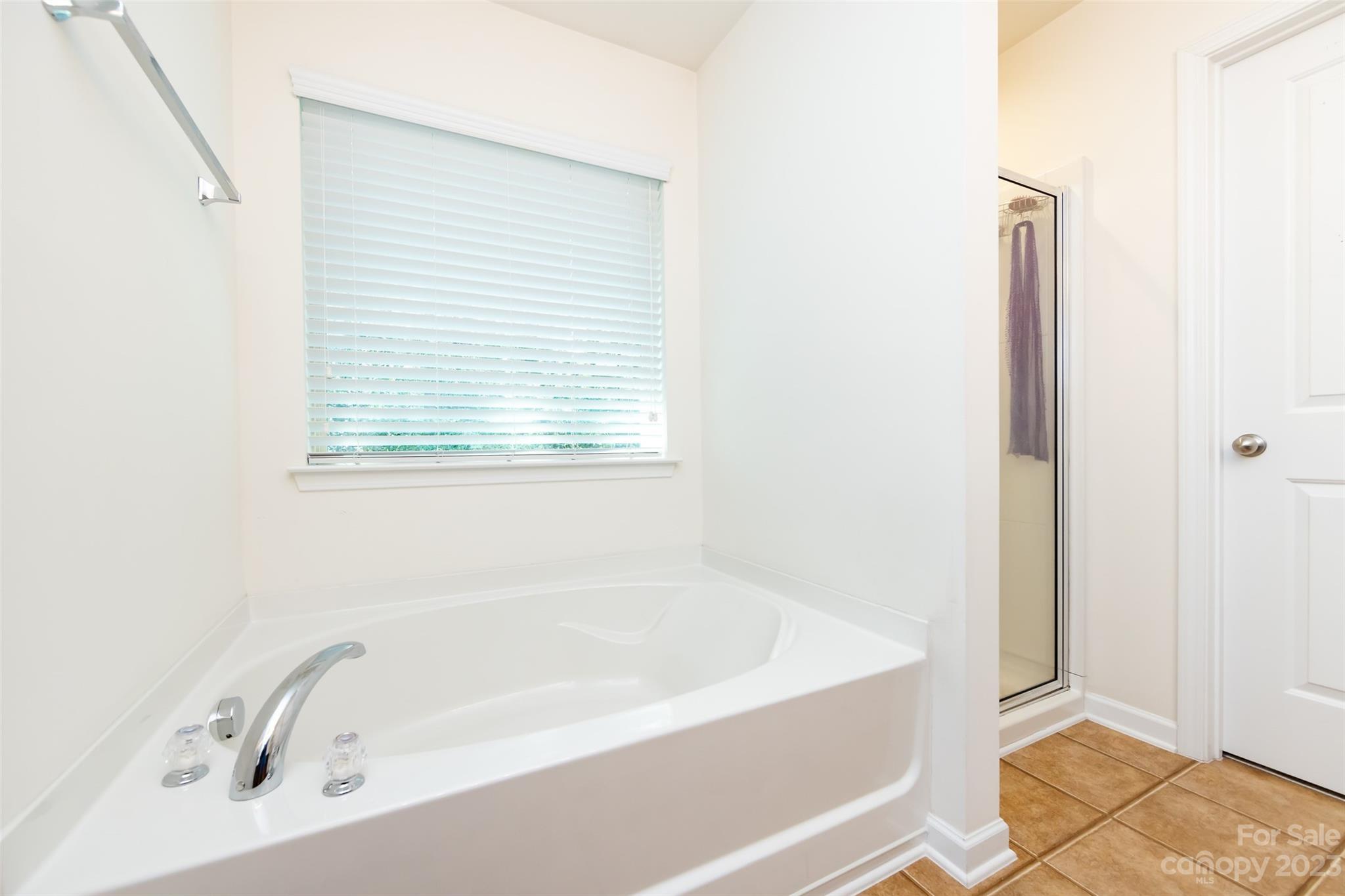807 Rook Road Charlotte, NC 28216 - Photo 33 of 43 a white bath tub sitting next to a window