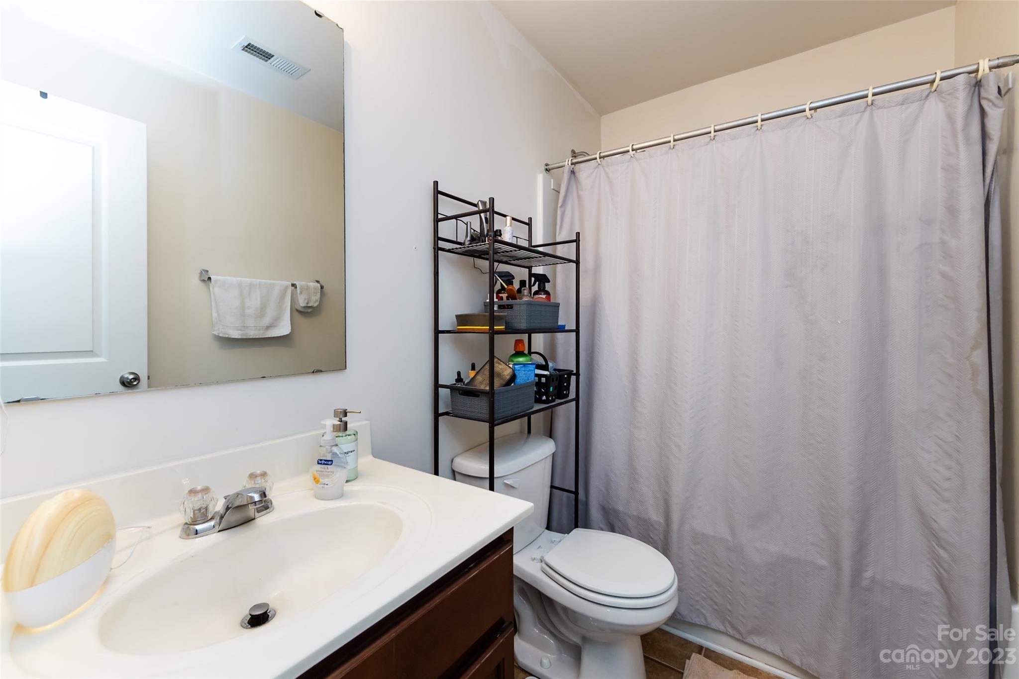 807 Rook Road Charlotte, NC 28216 - Photo 37 of 43 a bathroom with a sink a toilet and shower curtain