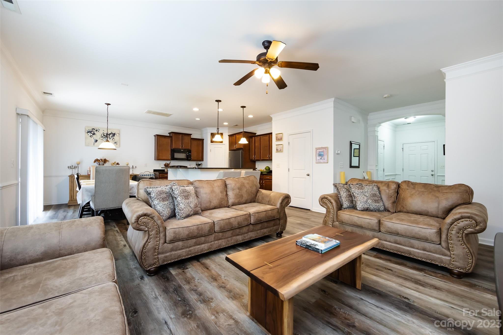 807 Rook Road Charlotte, NC 28216 - Photo 10 of 43 a living room with furniture kitchen view and a chandelier