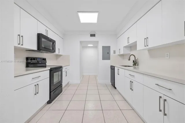 a kitchen with stainless steel appliances a sink dishwasher stove top oven and cabinets