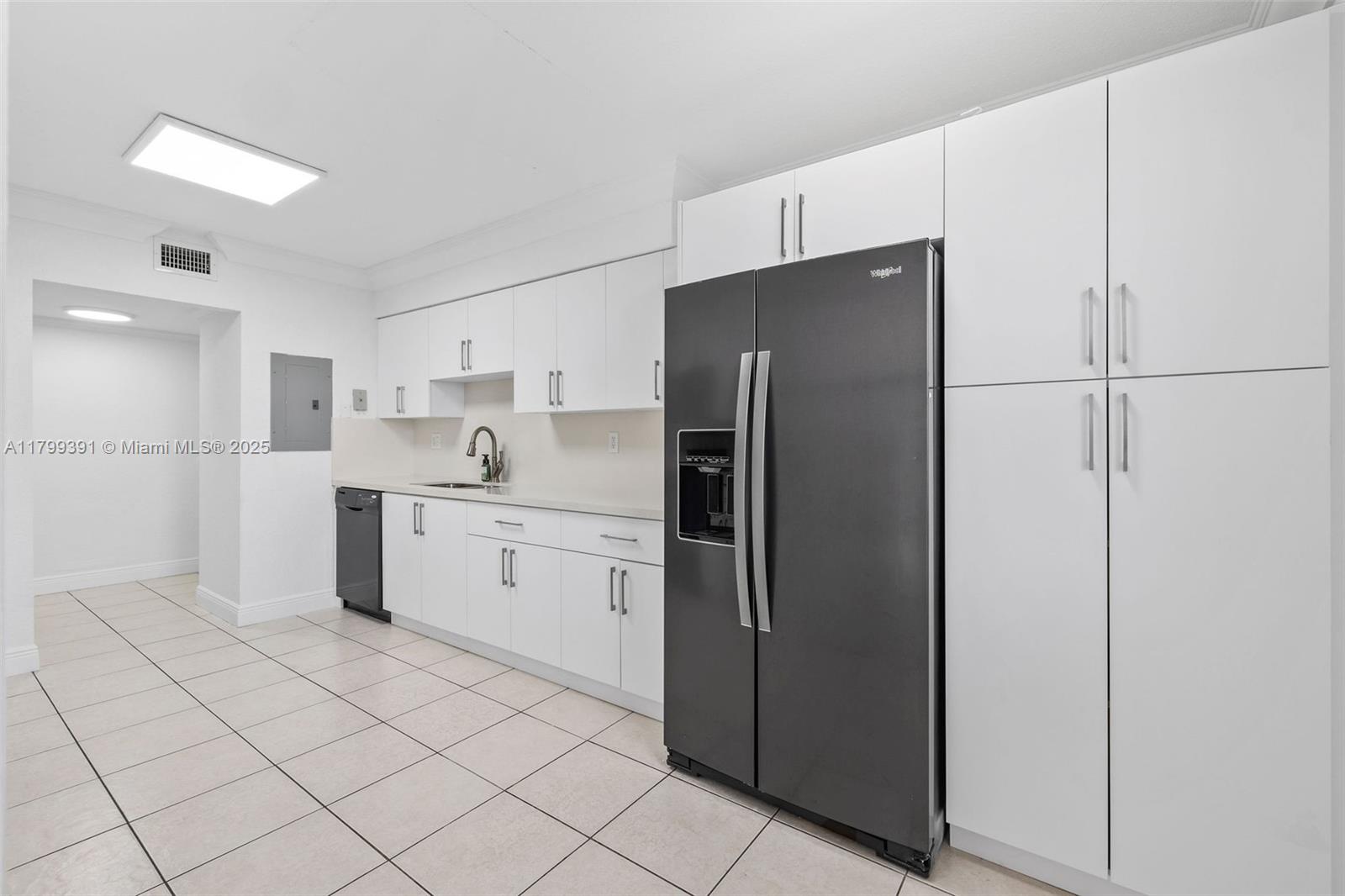 8401 Northwest 8th Street, Unit 401 Miami, FL 33126 - Photo 13 of 35 a kitchen with white cabinets and refrigerator