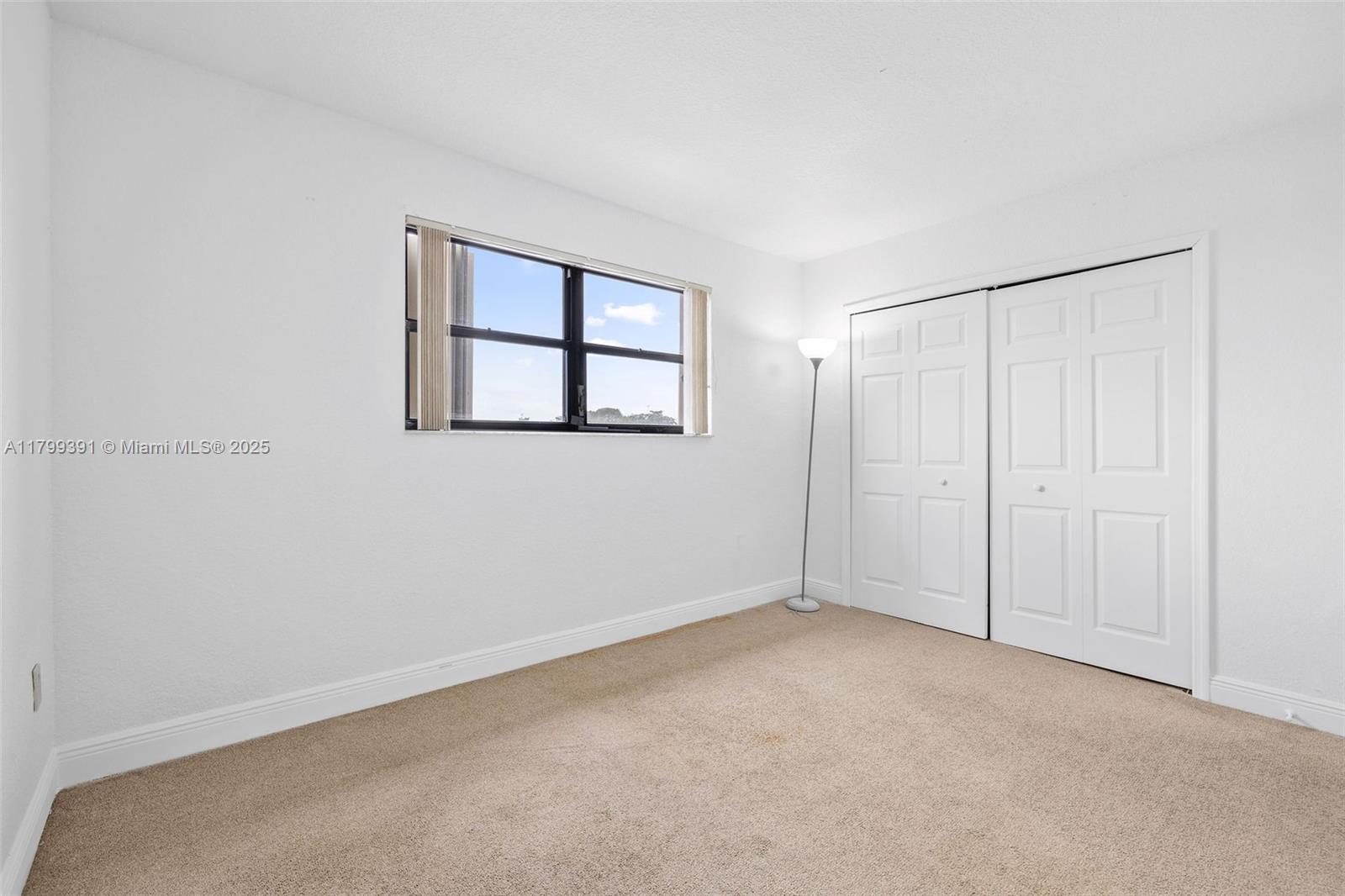 8401 Northwest 8th Street, Unit 401 Miami, FL 33126 - Photo 21 of 35 a view of an empty room with a window