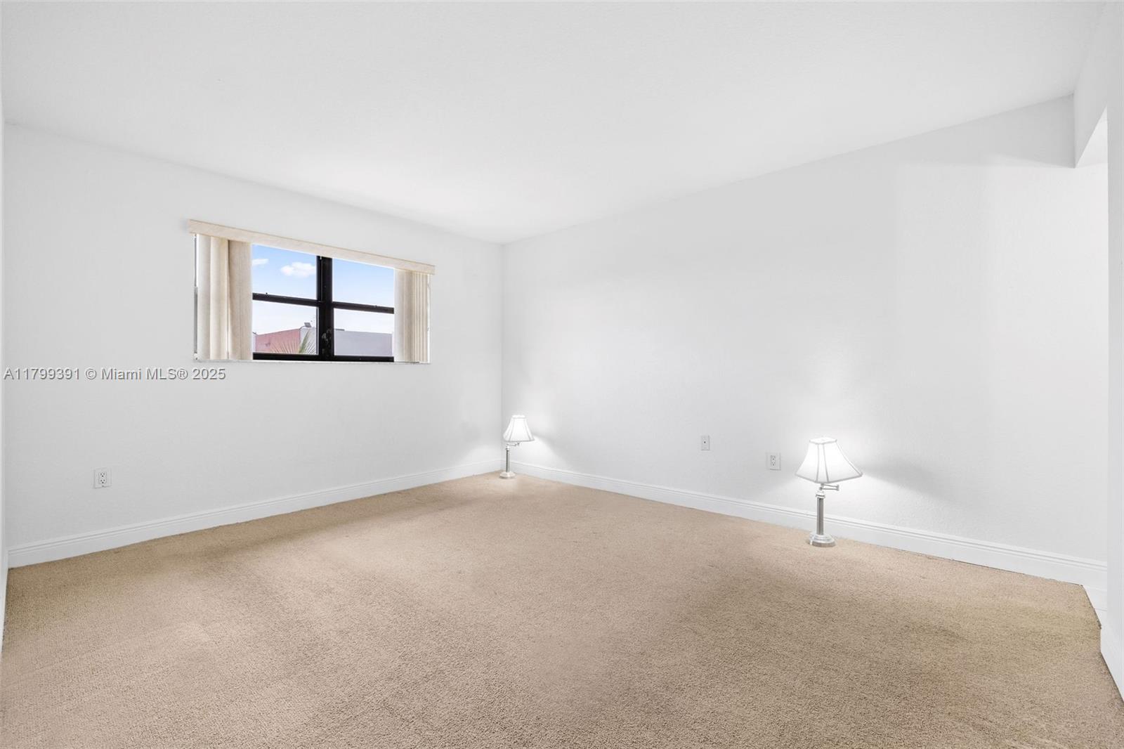 8401 Northwest 8th Street, Unit 401 Miami, FL 33126 - Photo 27 of 35 an empty room with windows and closet