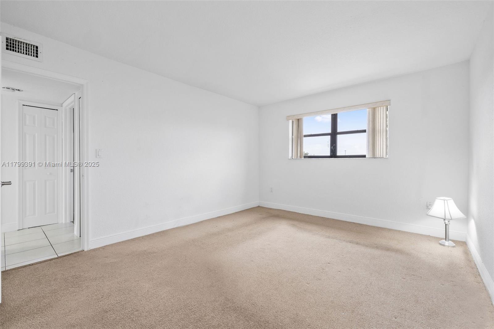 8401 Northwest 8th Street, Unit 401 Miami, FL 33126 - Photo 28 of 35 an empty room with windows and closet