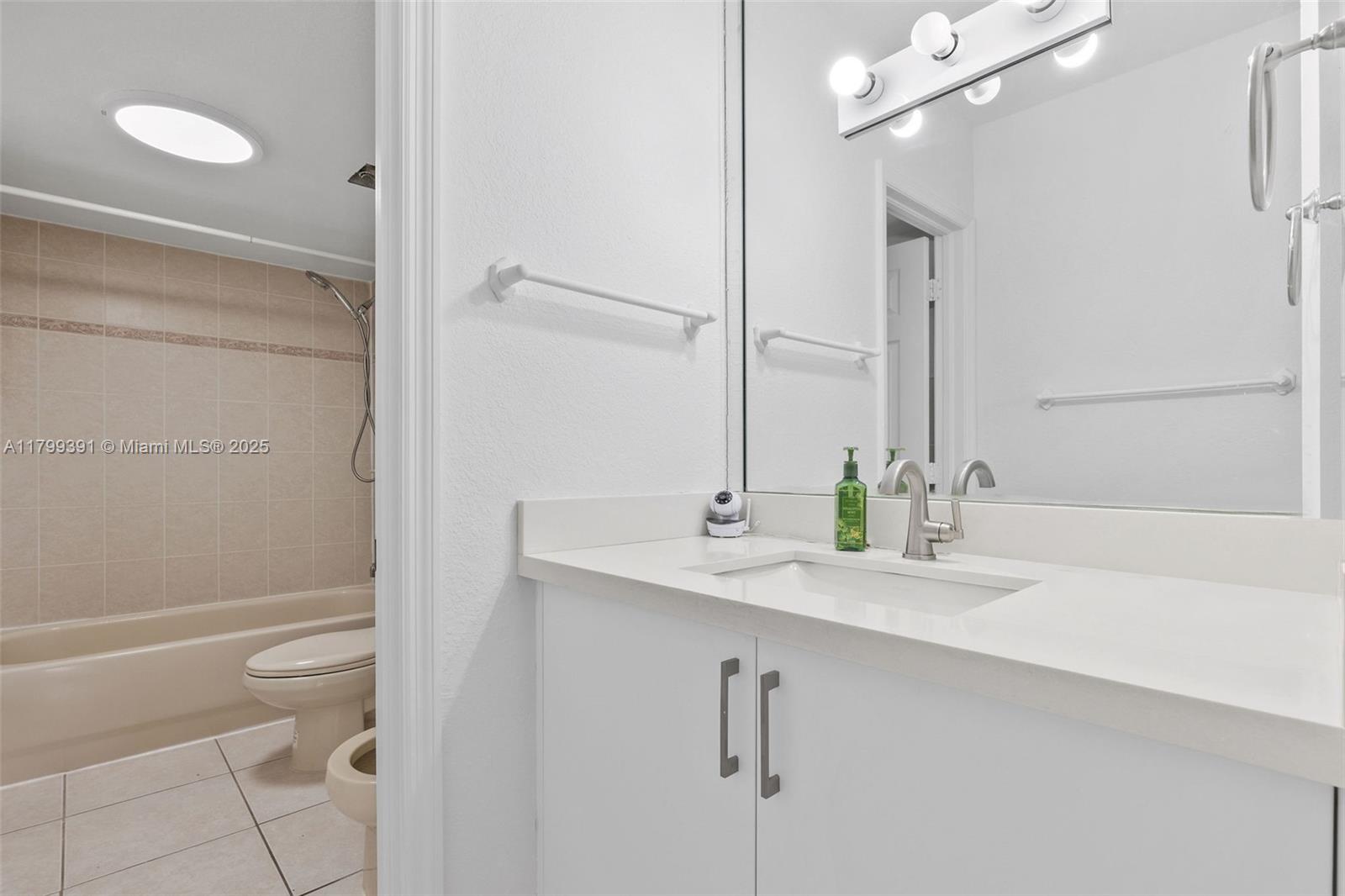 8401 Northwest 8th Street, Unit 401 Miami, FL 33126 - Photo 30 of 35 a bathroom with a granite countertop sink a toilet and shower