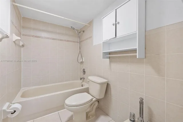 a bathroom with a bath tub with a shower