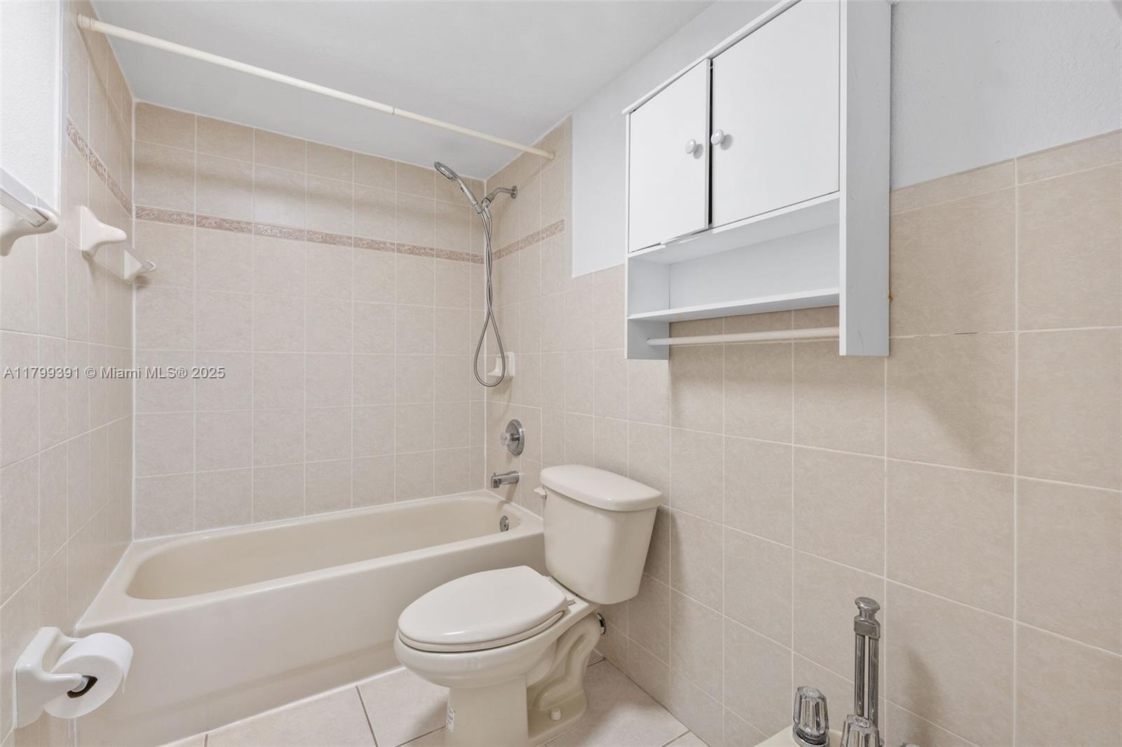 8401 Northwest 8th Street, Unit 401 Miami, FL 33126 - Photo 31 of 35 a bathroom with a bathtub a toilet and a shower