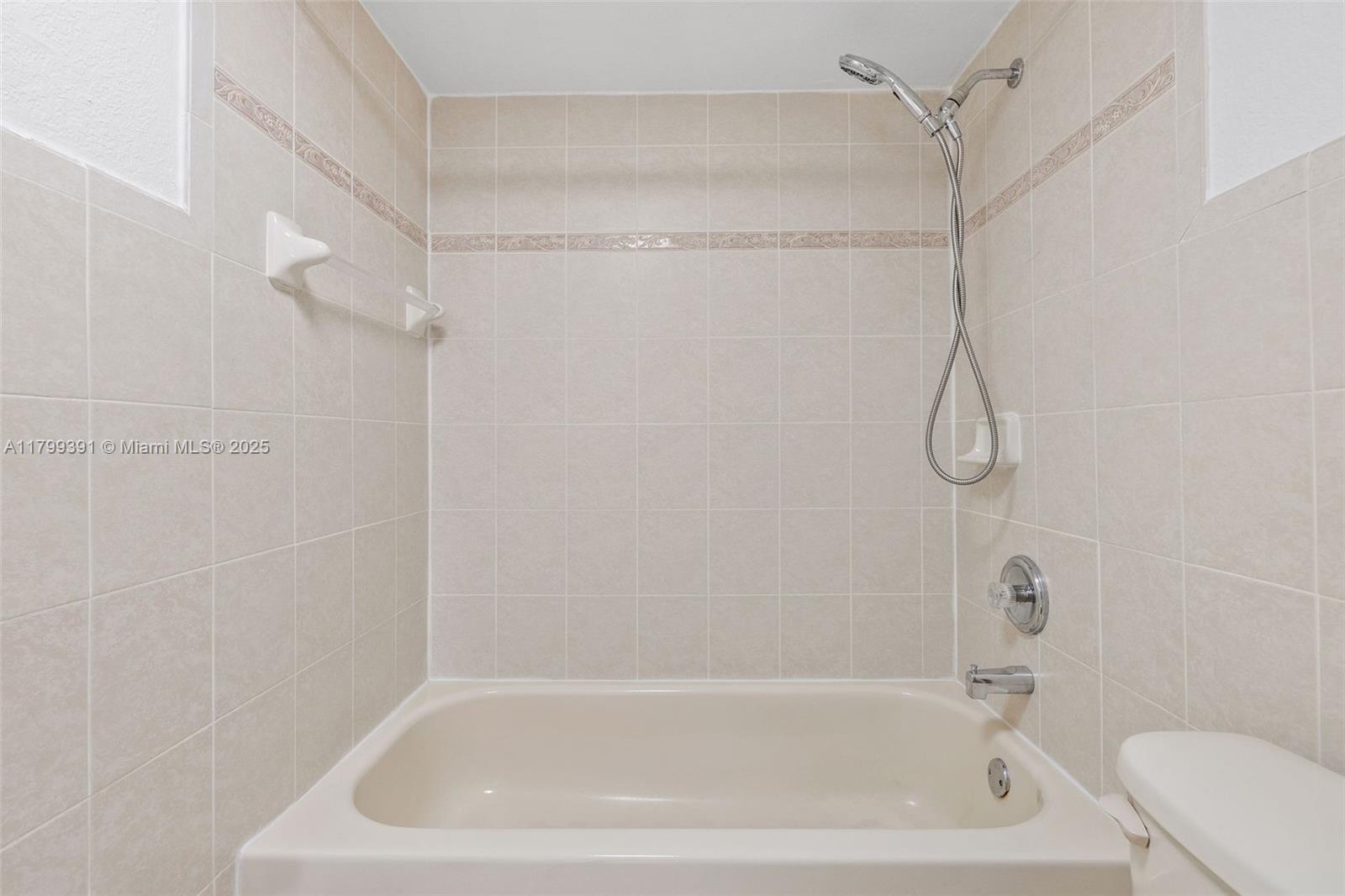 8401 Northwest 8th Street, Unit 401 Miami, FL 33126 - Photo 32 of 35 a bathroom with a bath tub with a shower