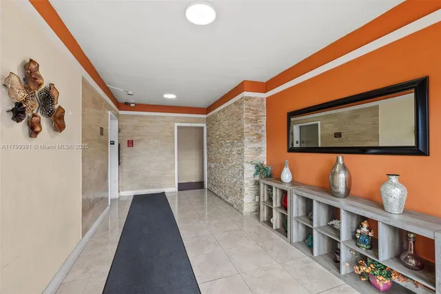 a hallway with windows and book shelf