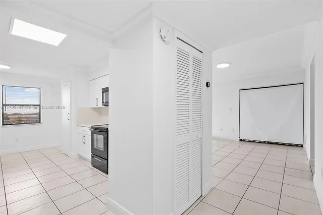 a view of a kitchen with white cabinets