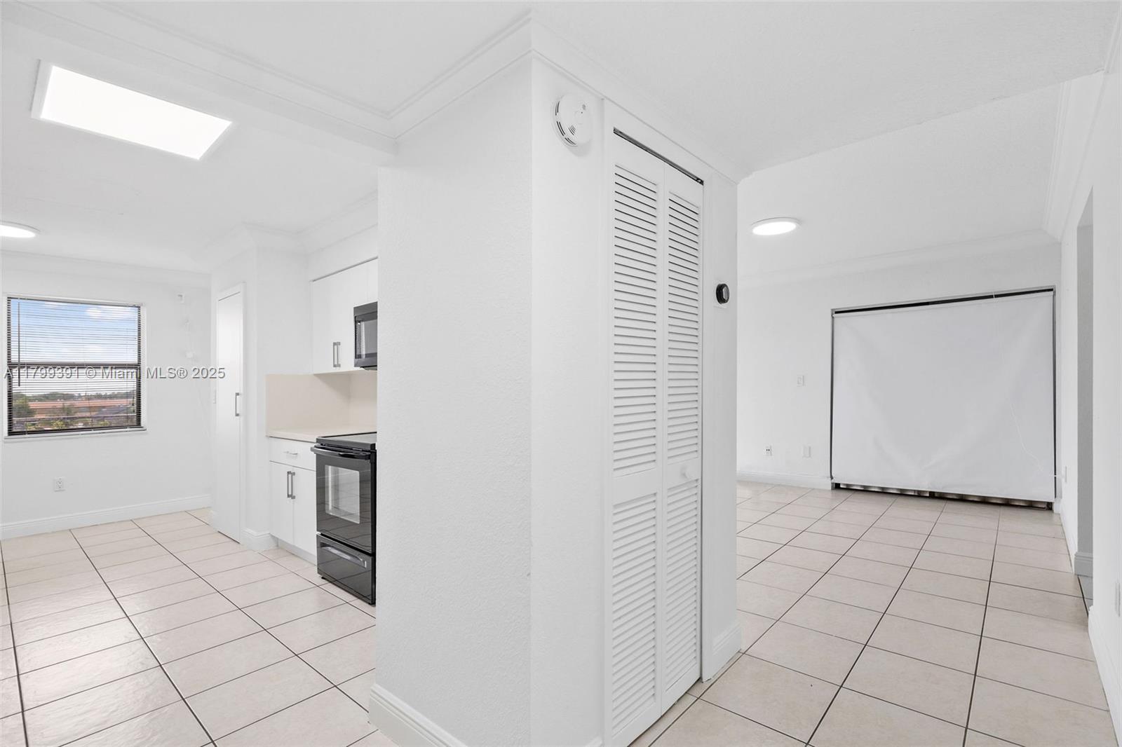 8401 Northwest 8th Street, Unit 401 Miami, FL 33126 - Photo 7 of 35 a view of a kitchen with white cabinets