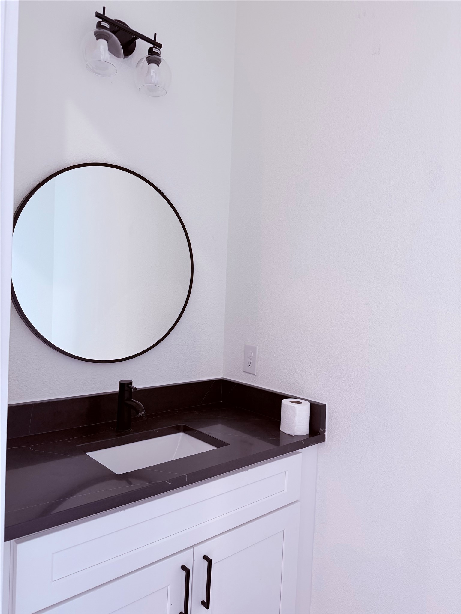 1417 Kramer Lane, Unit 7 Austin, TX 78758 - Photo 15 of 24 A well-appointed bathroom vanity with a sleek dark countertop and modern fixtures.